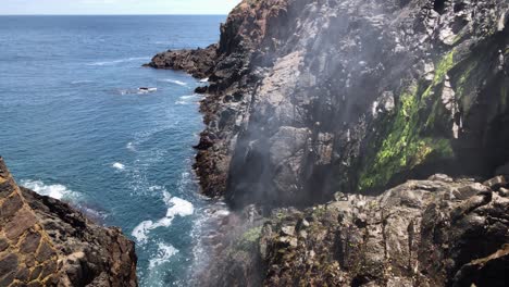 Horizontal-Slow-Motion-steady-shot-clip-of-the-Ensenada,-Mexico-Bufadora-also-known-as-blowhole-or-geyser,-expulsing-water-through-the-mountains-and-rocks