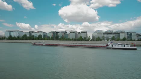 Boat-ride-through-Danube,-summer-afternoon,-cargo-ship,-German-flag