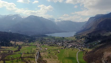Aerial-View-Of-Valley-Floor-With-Lake-Bohinj-In-The-Background