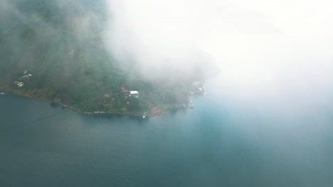 Drone-aerial-flying-high-over-the-clouds-in-Lake-Atitlan,-Guatemala,-Central-america