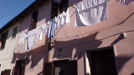 Laundry-drying-along-the-facade-of-a-building-in-the-medieval-village-of-Borghetto-di-Ostia-in-the-outskirts-of-Rome