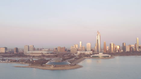 Aerial-view-of-the-south-area-of-Chicago-with-the-Shedd-Aquarium,-the-Soldier-Field-and-the-planetarium-during-the-sunset