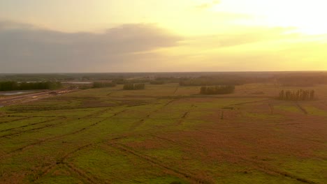 Aerial-view-of-a-cloudy-hazy-sunset-over-the-grasslands-of-Land-O'-Lake-in-Florida