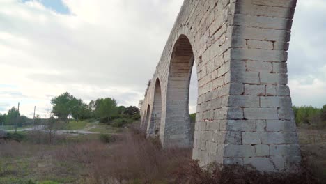 Old-stone-aqueduc-in-south-of-France,-empty-scenery-of-a-tourist-site-deserted-during-Covid-19-pandemic-lockdown,-roman-architecture