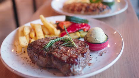 Serving-steak-with-fries-and-vegetable-on-a-grill