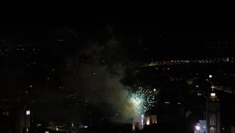 Drone-aerial-view-of-fireworks-in-Kaunas,-Lithuania