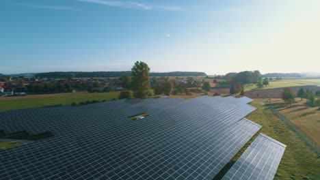 Solar-panels-reflecting-the-sun-in-a-field-aerial