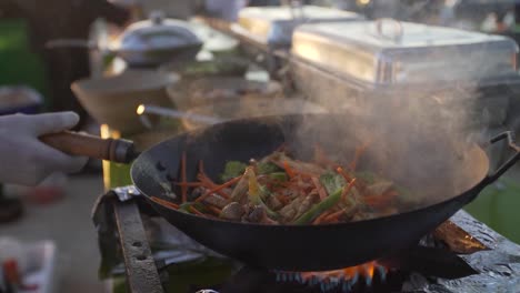 Close-up-shot-of-chef-cooking-fresh-meal-in-wok-pan-on-Moroccan-Street-Market
