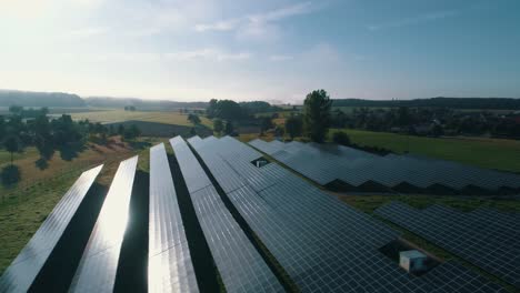 Sun-reflecting-off-of-solar-panels-in-a-field-aerial