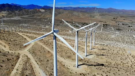 Nice-sweep-R-to-L-to-line-up-shot-of-spinning-blades-of-windmills,-wind-turbines-energy,-green,-renewable,-power-generating-farm,-aerial-4k-drone,-Palm-Springs,-Coachella-Valley,-Cabazon,-California