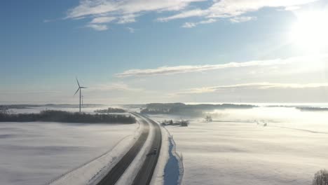 Birds-eye-view-of-windmills-and-highway-in-cold-winter-day