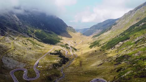 Beautiful-winding-road-in-the-heart-of-the-Carpathian-Mountains,-captured-with-a-drone