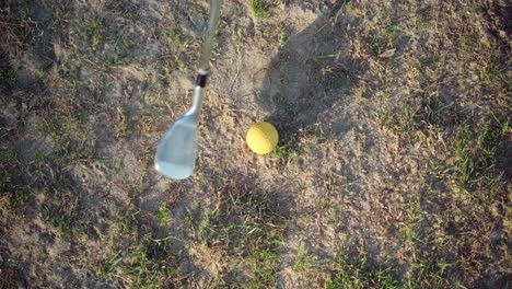Golf-ball-hit-by-golfer,-view-from-above,-fast-shot-with-dust-on-the-fairway