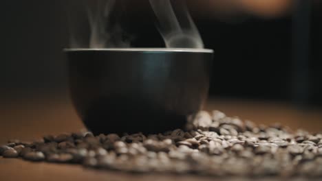 Steam-over-a-cup-of-fresh-coffee-on-a-wooden-table-slow-motion