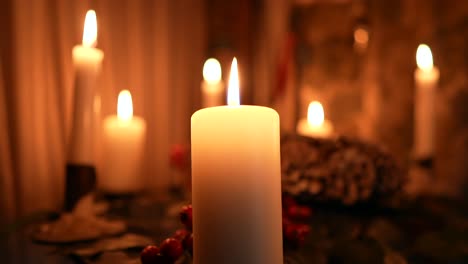 Many-candles-burning-in-slow-motion-in-the-dark,-romantic-vibe-or-festive-decorations-for-Christmas-or-a-birthday