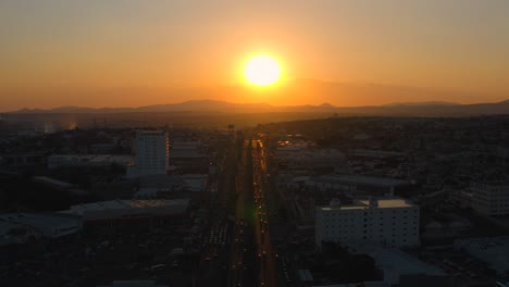 Beautiful-sunset-in-a-big-city,-shot-with-drone