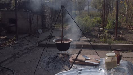 Bean-soup-boiling-in-cauldron-at-the-stake-on-fire-in-garden