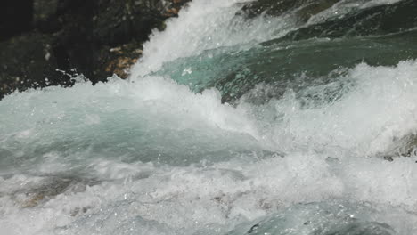 close-panning-view-of-fresh-and-clear-water-rapids-in-slowmotion