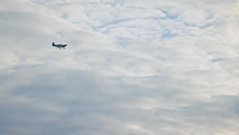 single-engine-small-airplane-crossing-the-cloudy-sky.-slowmotion