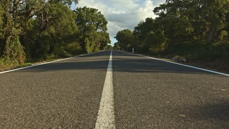 Wide-angle-shot-of-majestic-endless-country-asphalt-road,-dolly-forward-view