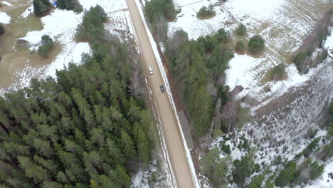 Aerial-car-chase-on-gravel-in-first-snow