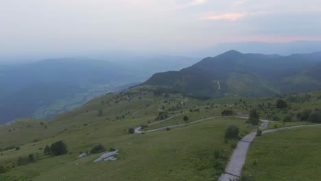 A-drone-shot-on-top-of-a-mountain--The-view-is-amazing-there-are-mountains-in-the-distance