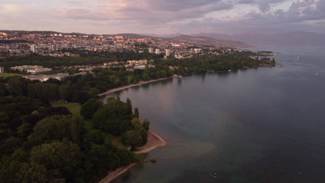 Slow-aerial-view-above-of-the-Lake-Geneva-shoreline-in-Lausanne,-Switzerland