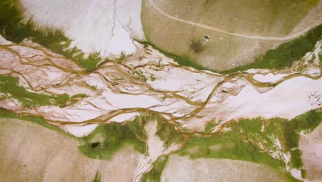 Aerial-View-Of-River-In-The-Valley-Flowing-Into-Arashan-Lake-In-Angren-Plateau,-Namangan,-Uzbekistan