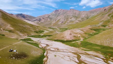 Aerial-View-Of-Mountain,-Valley,-And-Drought-Stream-Near-Camping-Area-In-Uzbekistan