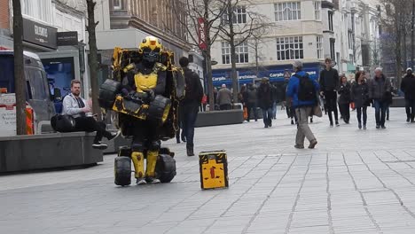 Unidentified-man-in-Bumblebee-robot-costume-performs-transformer-street-performance-in-busy-city-centre