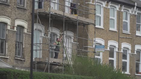 This-is-a-clip-of-Scaffolders-erecting-Scaffolding-on-a-house-in-London,-England