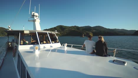 SLOWMO---People-enjoying-the-sunset-on-boat-in-Marlborough-Sounds,-New-Zealand