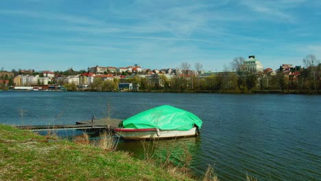 Boat-in-Vltava-river-in-Prague-wind-blowing-in-slow-motion-clear-sky-sunny-day