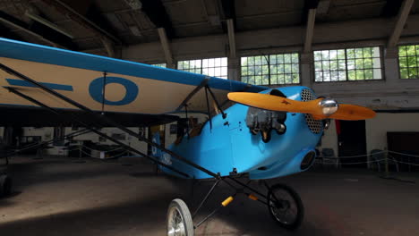 Stunning-Pull-Out-Shot-of-an-Airplane-in-Hangar-Revealing-Wooden-Propellers