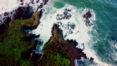 Waves-crash-into-rocky-coves-eroded-out-of-tall-cliffs-in-California