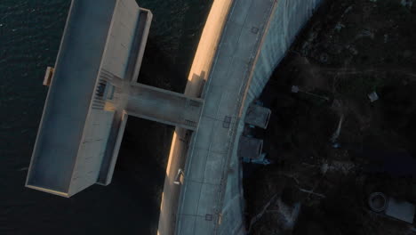 Dam-wall-dramatic-light-birdseye-rotating-dolly-depth-on-Lake-Barragem-do-Alto-Rabagao-aerial-view-Montalegre