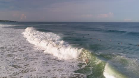 Aerial-drone-shot-of-a-surfer-surfing-a-tube-barrel-wave-and-jumping-in-Zicatela-beach-Puerto-Escondido,-Oaxaca