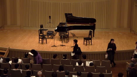 Asian-spectators-entrance-and-sitting-at-a-concert-hall