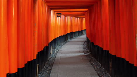 Kyoto-Japan---Circa-pan-down-shot-of-famous-Fushimi-Inari-Kyoto-Temple-red-wooden-gate-passage,-traditional-shinto,-no-people,-daylight