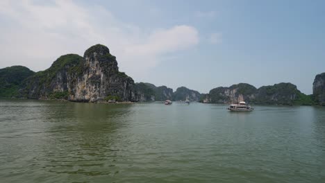 Sea-level-shot-of-cruise-ship-and-rocky-cliffs-of-Halong-Bay-in-Vietnam