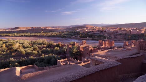 Panning-wide-shot-of-the-river-and-desert-valley-under-Ait-Ben-Haddou-in-Morocco