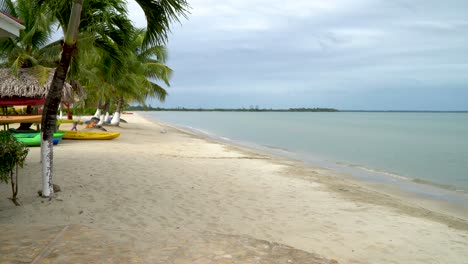 Calm-ocean-laps-at-tropical-white-sand-beach-in-Hoskins,-Belize