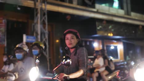 Crossing-through-busy-streets-passing-asian-woman-smiling-at-the-camera-in-slow-motion