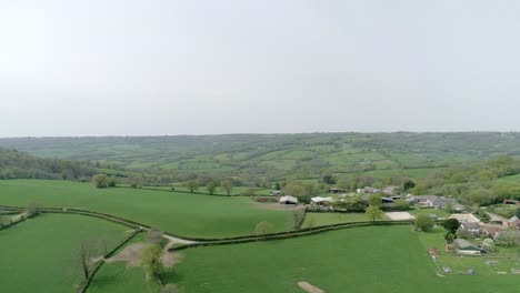 Wide-aerial-of-a-gorgeous-green-spring-Devon-fielded-valley