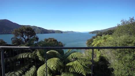 Girl-lying-in-bed-in-luxury-retreat-with-amazing-view-of-Marlborough-Sounds,-New-Zealand