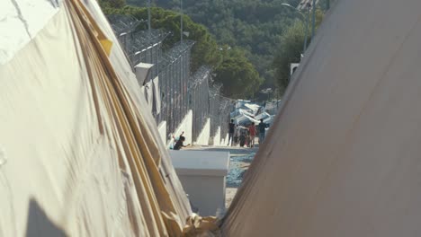 Refugee-Kids-Playing-and-Running-Next-to-a-Barbed-Wire-Fence-in-a-Refugee-Camp