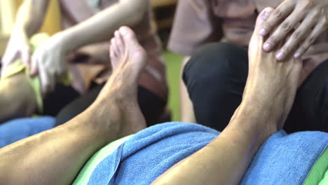 4k-close-up-footage-of-thai-foot-massage-at-tourist-on-Khao-San-Road-In-Bangkok,-Thailand
