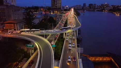 Moving-aerial-view-of-a-busy-city-highway-at-night