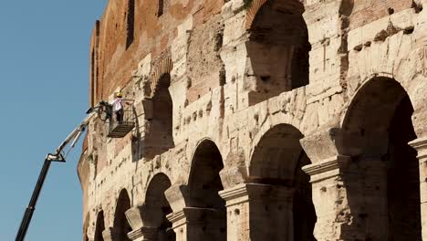 Worker-on-a-crane-process-a-restoration-on-the-Colosseum-in-Rome