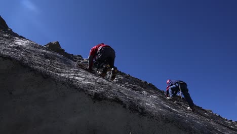 Himalayan-mountaineers-sitting---climbing-on-a-rocky-mountain-of-upper-Himalayas,-Uttarakhand,-India